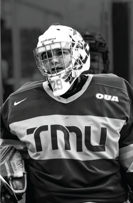 Close up portrait of TMU's hockey goalie coming off the ice
